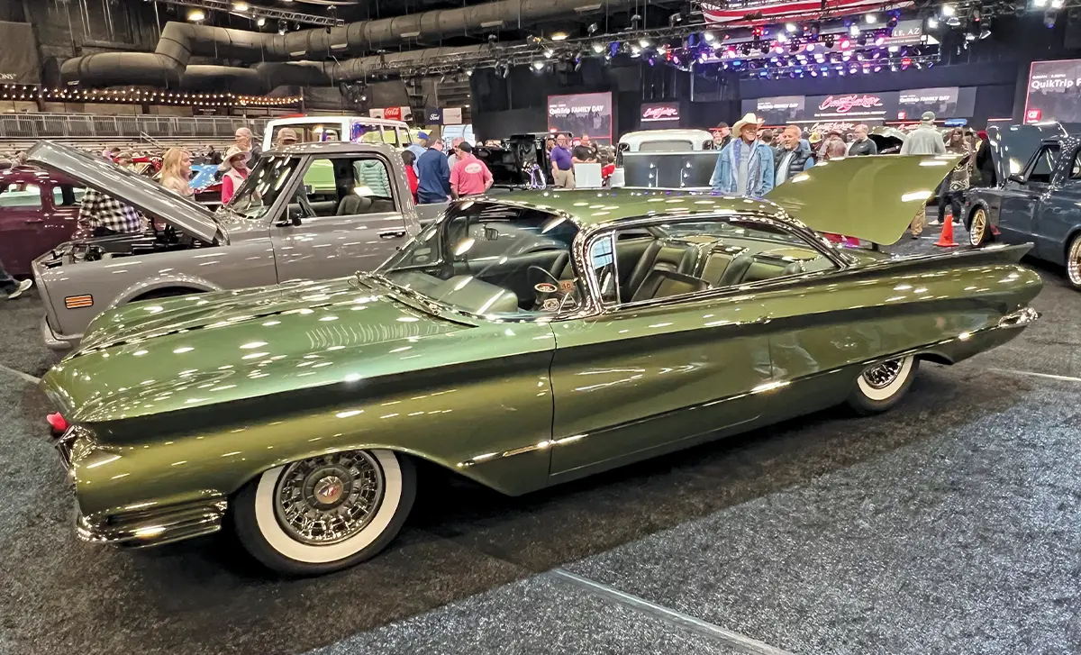 driver side view of a dark metallic chartreuse ’60 Buick Invicta with its trunk open