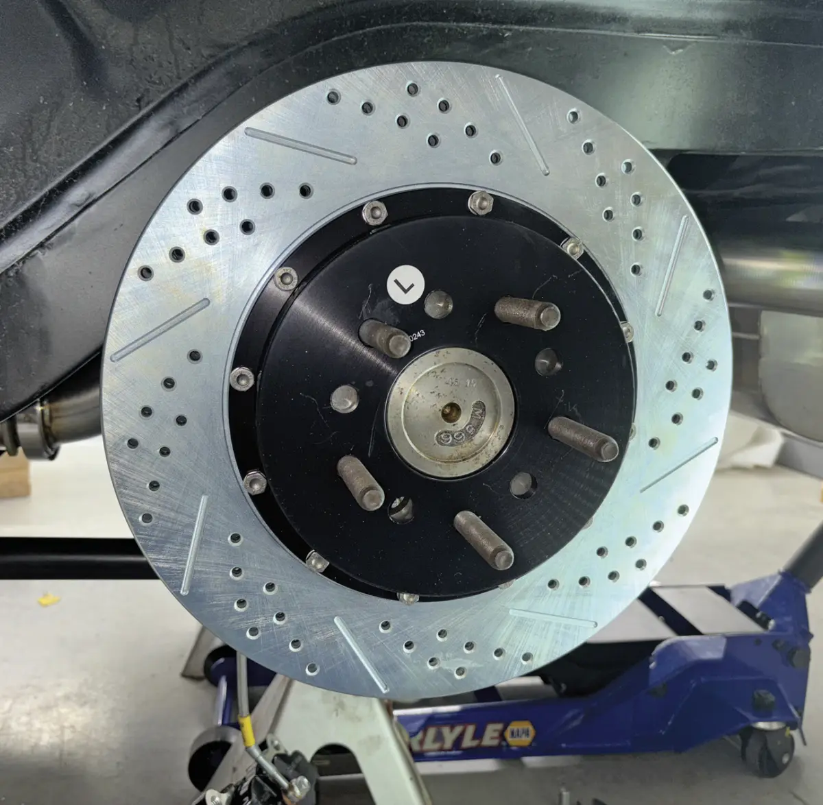 close up of the 14-inch rear rotor in place labeled with an "L" sticker