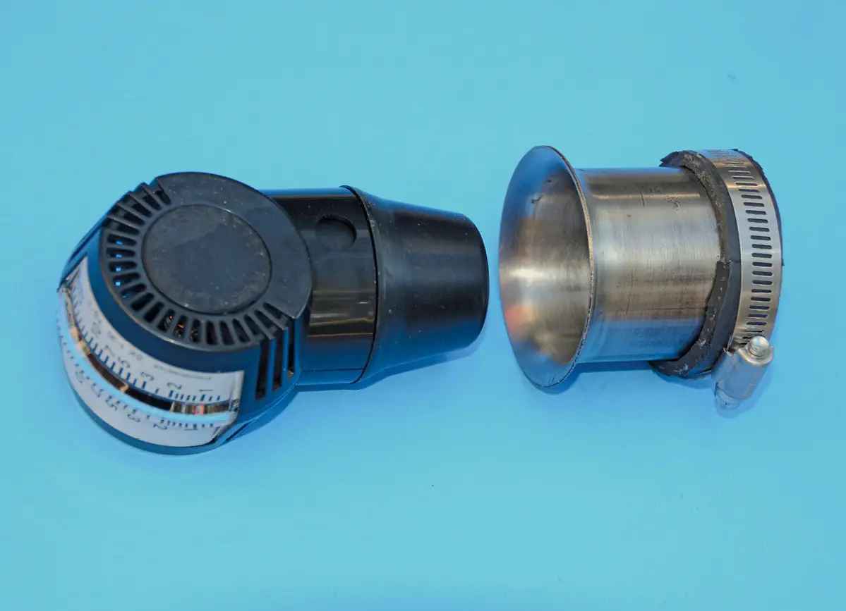 Our adapter is a very straightforward arrangement. The clamp holds a piece of radiator hose to the adapter/exhaust tubing. It does NOT clamp to the carburetor; it is simply held in place by hand.