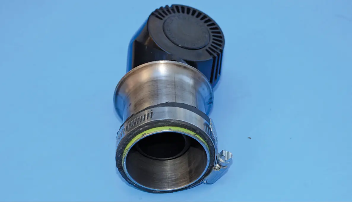 That rubber piece is clamped approximately 1/8-inch from the bottom of the tubing. This forms a small lip that centers the piece nicely on the carburetor.