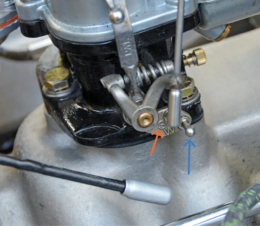 Before we tackled airflow, we moved the accelerator pump arm from the “W” post (blue arrow) to the “S” post (orange arrow). This makes for a less-aggressive accelerator pump that delivers less fuel. Removing vintage rod ends is as simple as sliding the sleeve back and pulling the rod off the pivot ball. You should never need a tool to pry the rod end off.