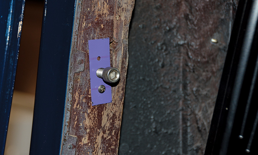 close up of a screw in a wood panel