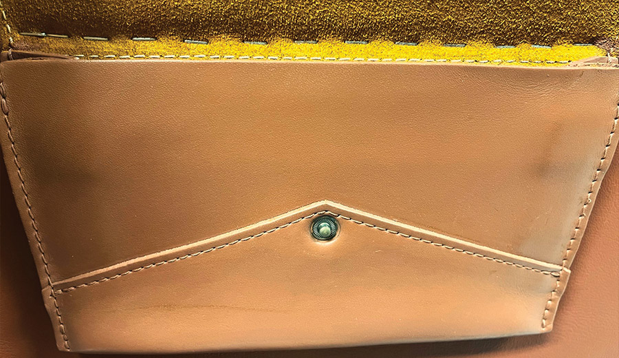 close up of the map pocket with staples added under the top fold