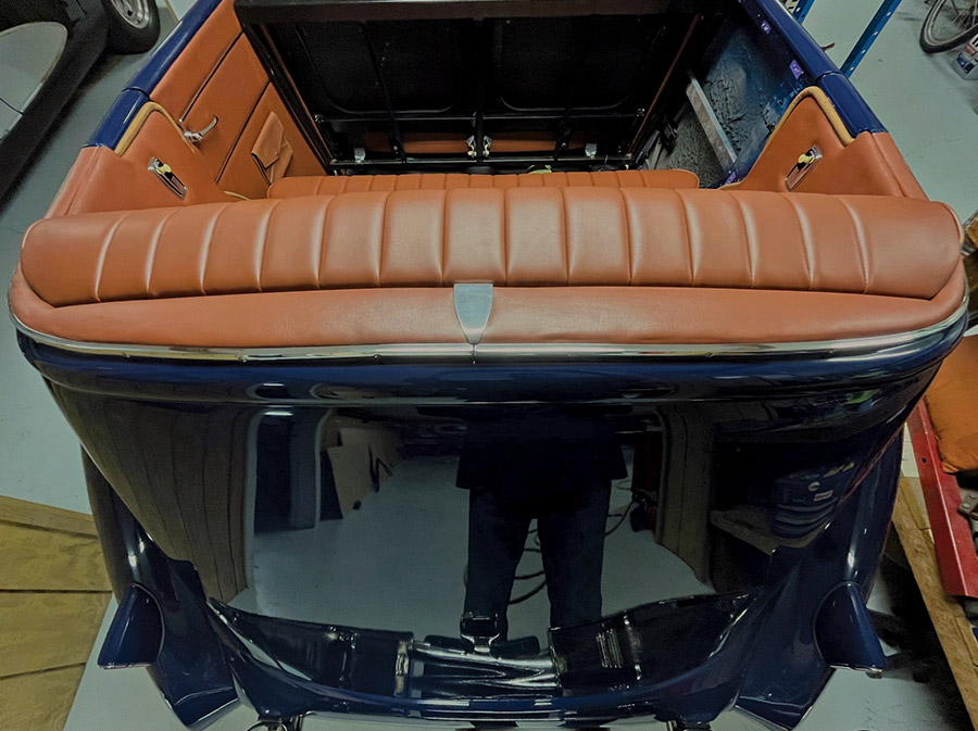 panel behind the seat with simple aluminum seam cover