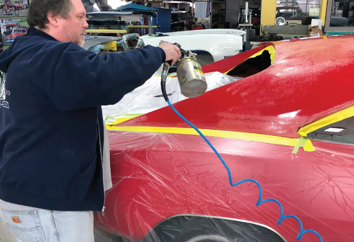 with plastic covering placed to protect all other areas of the Charger, the roof of the car is also sprayed with the Weldwood adhesive