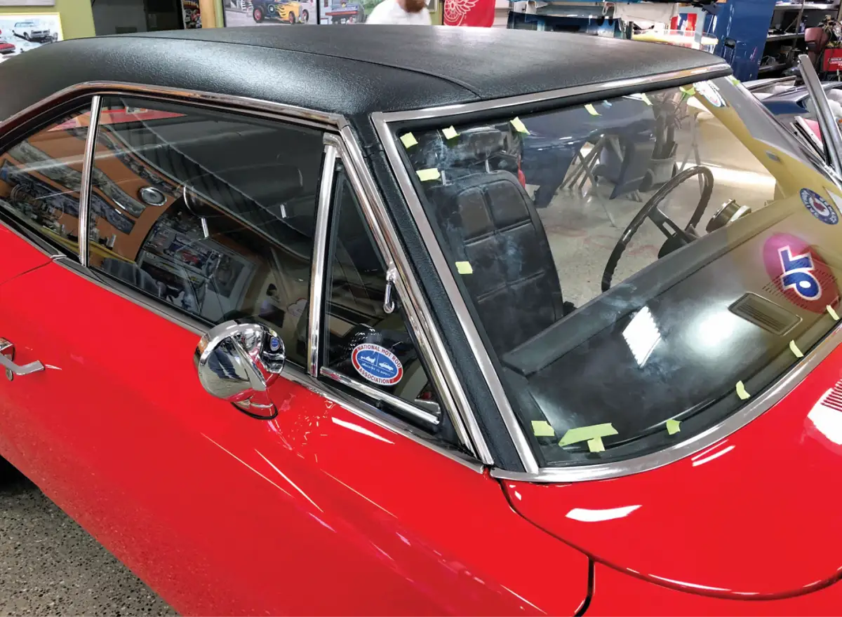 quarter passenger side high angle view of the newly installed vinyl top on the repaired red '69 Charger