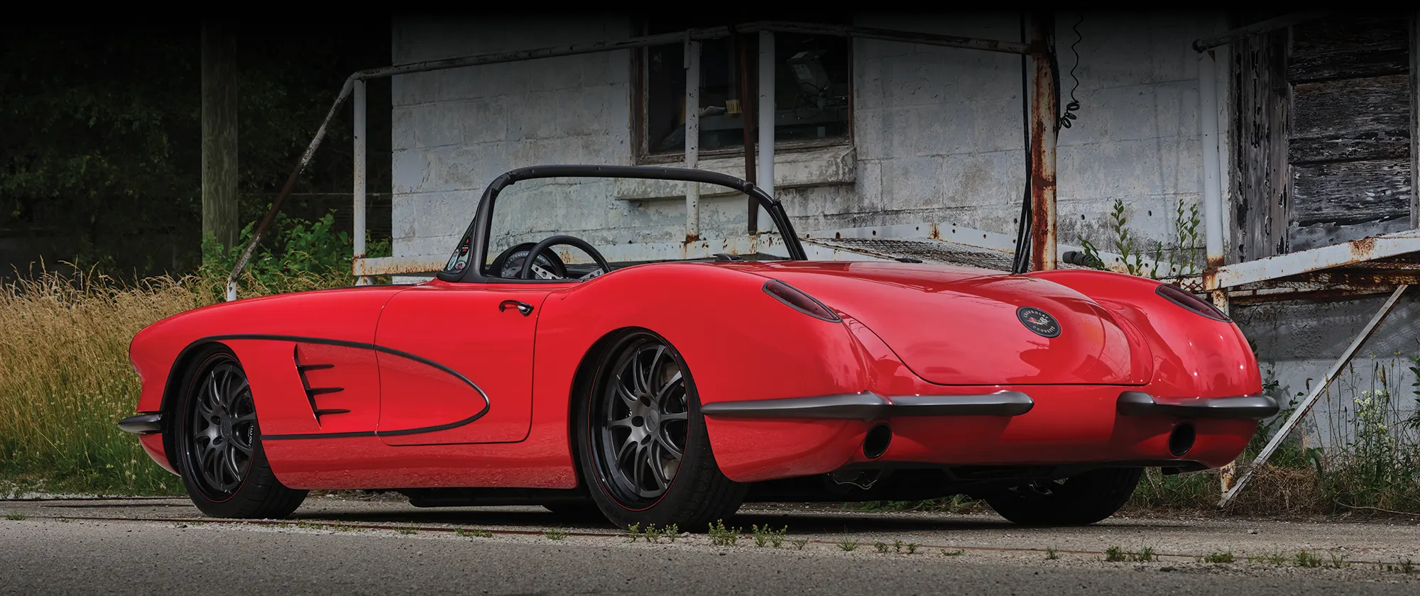 3/4 rear view of red 1959 Corvette with black details