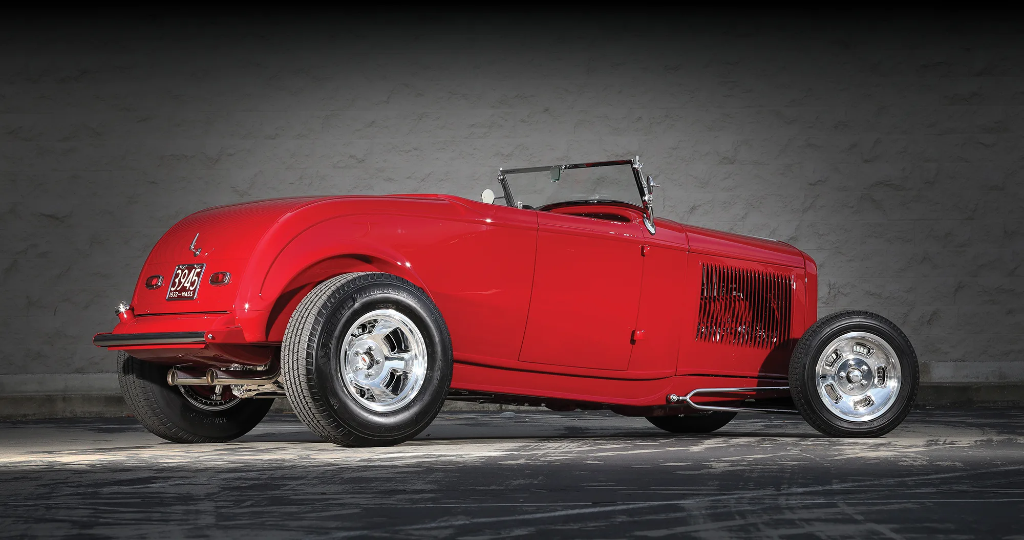 Rear view of a 1932 Ford Roadster, highlighting its vintage license plate and polished exhaust system