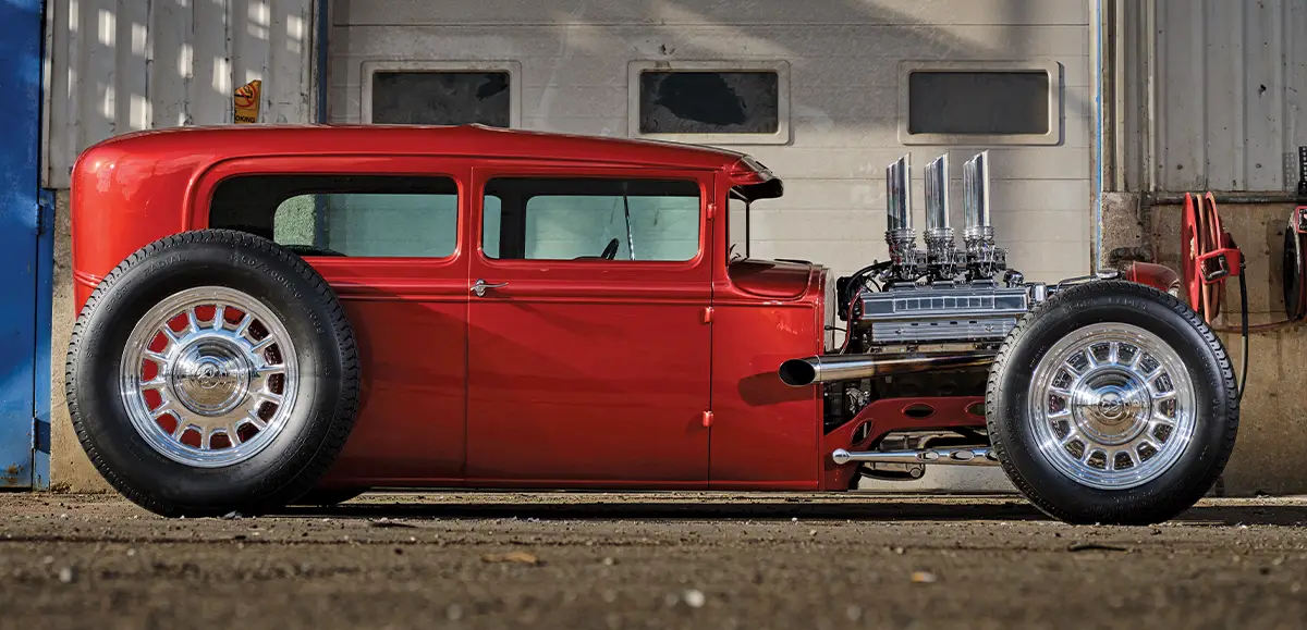 Passenger side view of Fiery Red 1930 Ford Sedan Custom