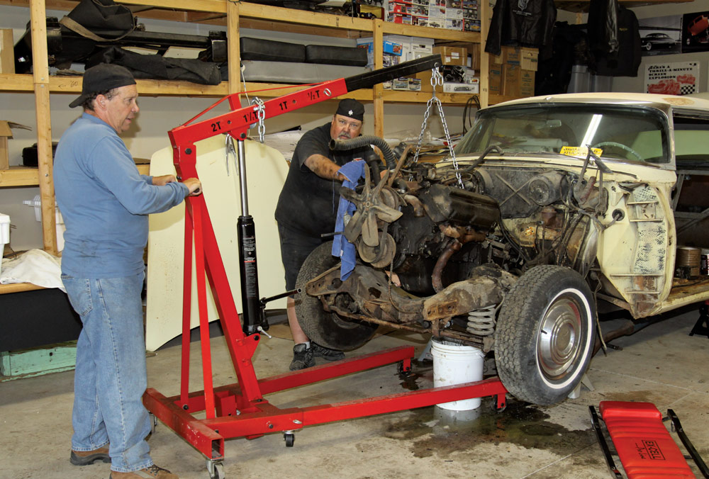 With the sheetmetal out of the way, the grimy 330ci Hemi and two-speed Powerflite transmission were removed