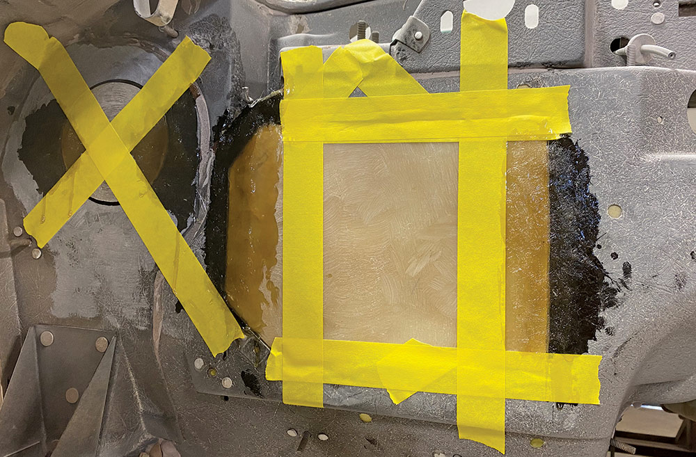 yellow masking tape holding fiberglass in place 