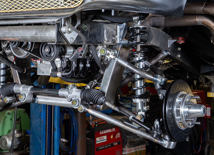 Front suspension setup on the 1955 Chevrolet Bel Air gasser, showcasing tubular control arms, coilovers, and disc brakes