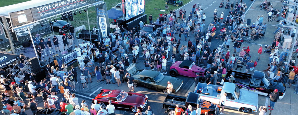 aerial view of a car show with people on a stage