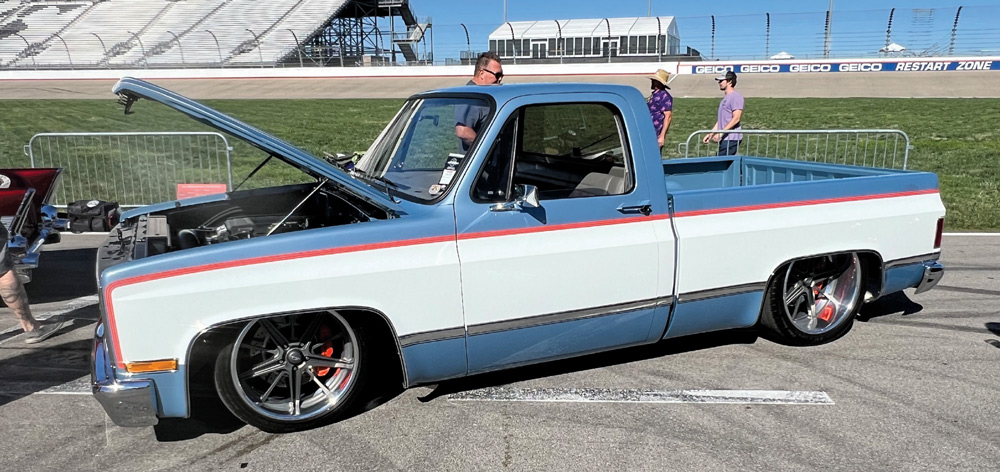 blue truck with white side at a car show