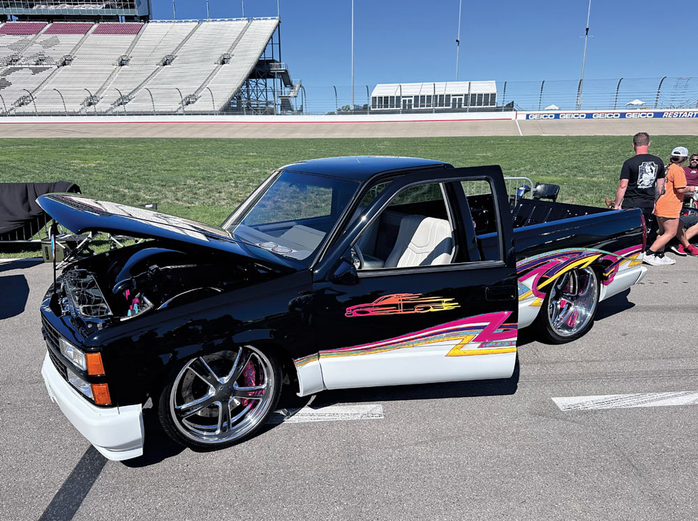 black truck with with bottom at a car show