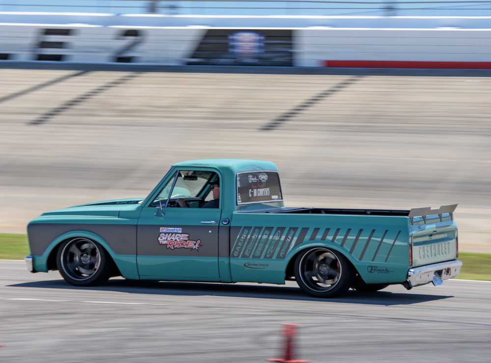 turquoise car driving on a track