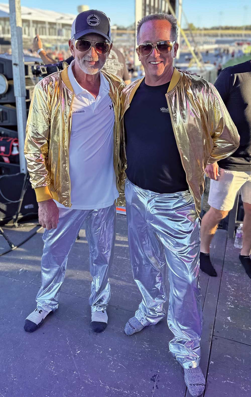 two men dressed in shiny gold jackets and silver pants
