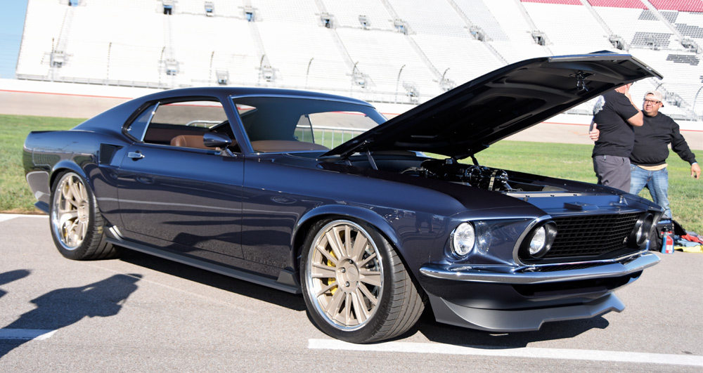 blue car with hood open at a car show