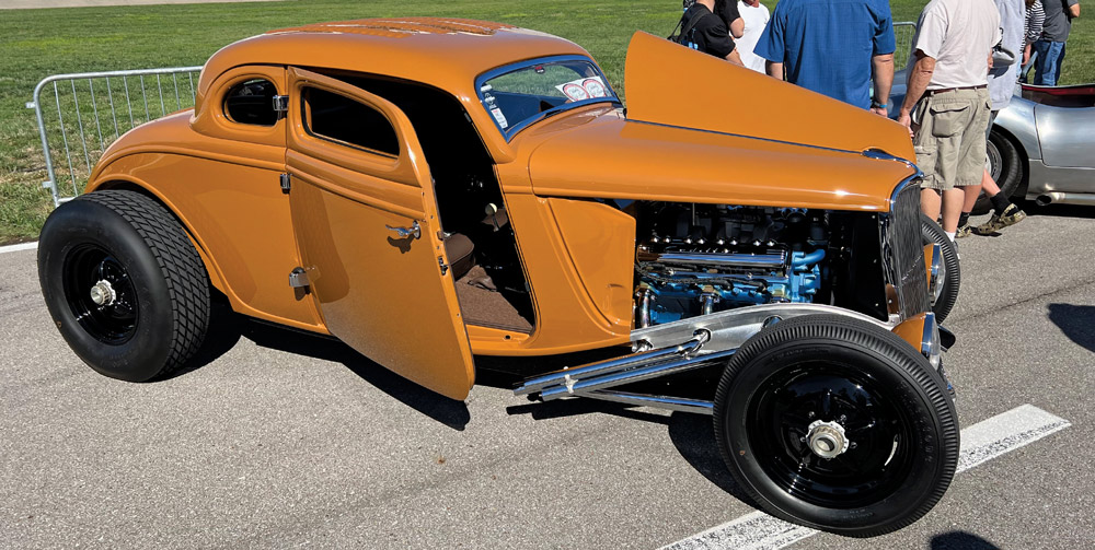 orange car at a car show