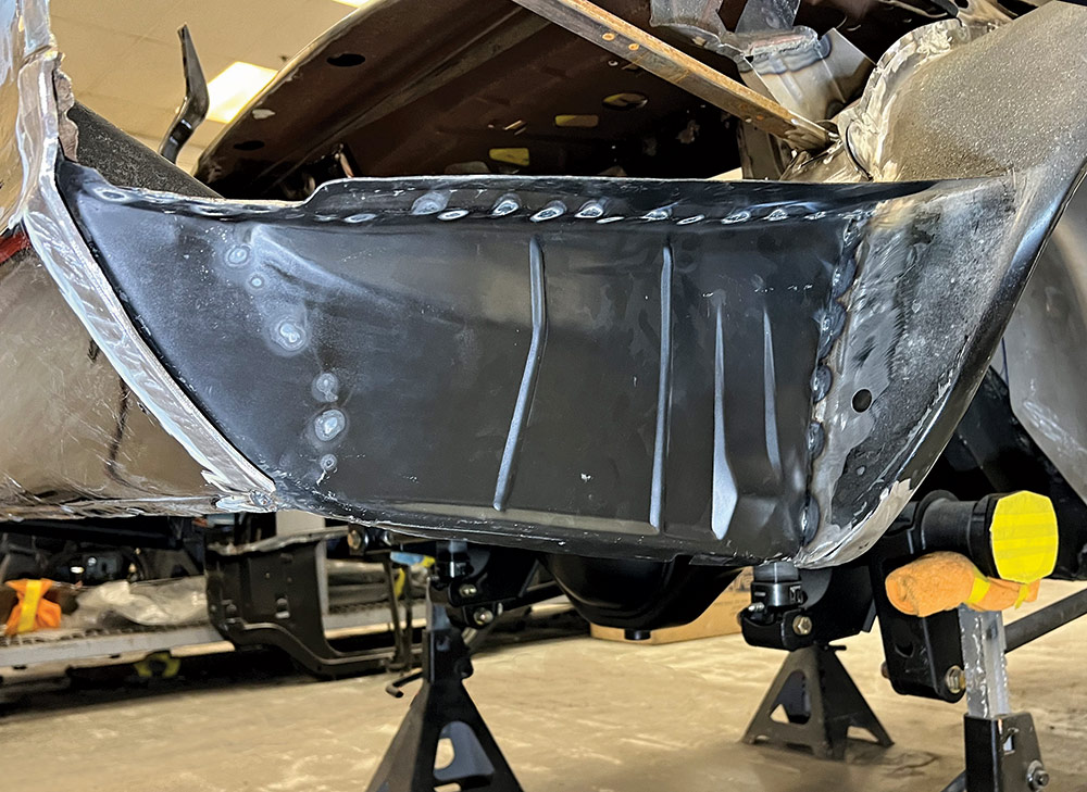 Rear end of a 1969 Camaro, the new quarter panel in place, showing progress in the restoration process