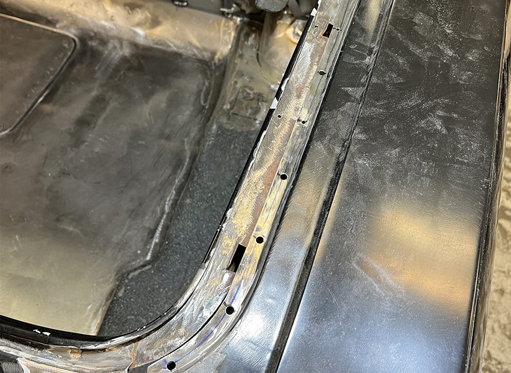 Close-up of the rear deck of a 1969 Camaro, showing refinished metalwork and welding seams