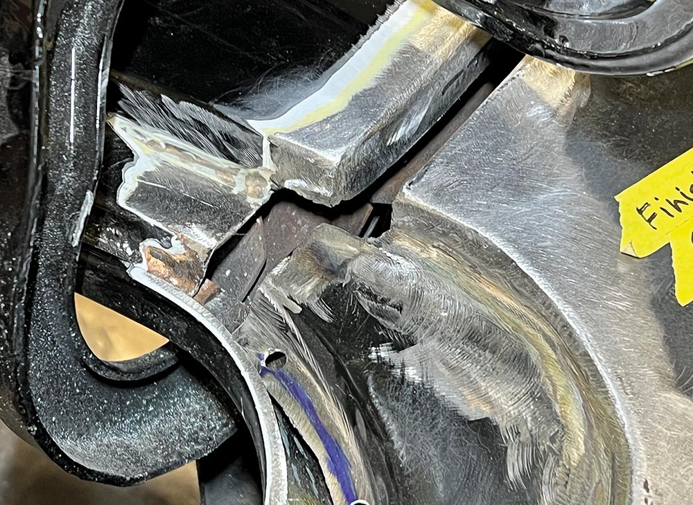Detailed view of a newly welded rear corner joint on a 1969 Camaro, marked for final adjustments