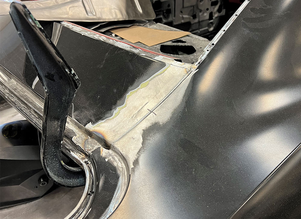 Rear quarter section of a 1969 Camaro, with welded and finished seams showing new panel work