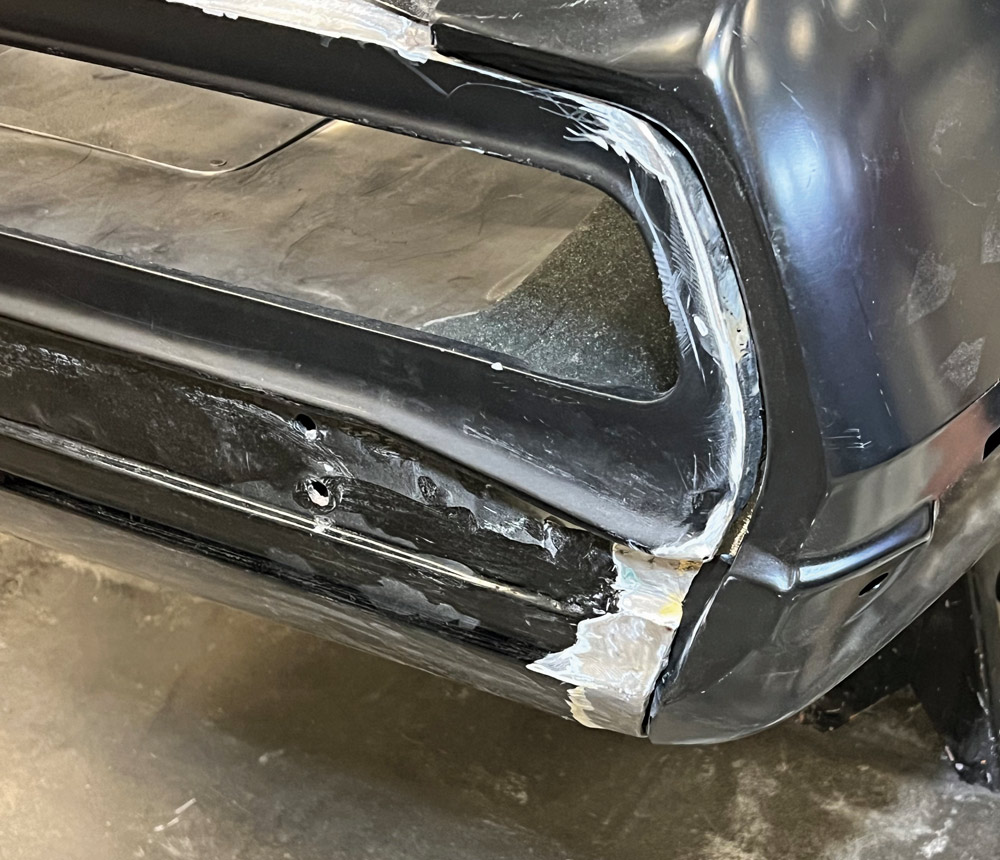 Rear tail light area of a 1969 Camaro with welds smoothed out and seams prepped for finishing