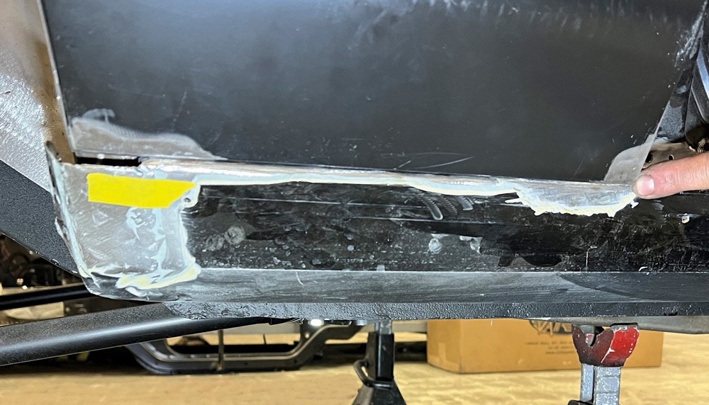 Underside corner of a 1969 Camaro with detailed panel alignment and seam sealer applied to the joints