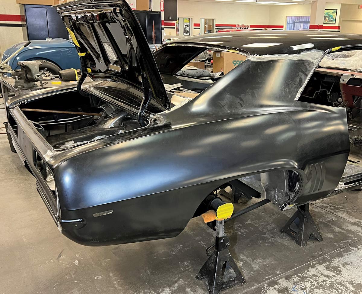 Full rear quarter view of a 1969 Camaro with the trunk lid open, showing fitted new panels and bodywork