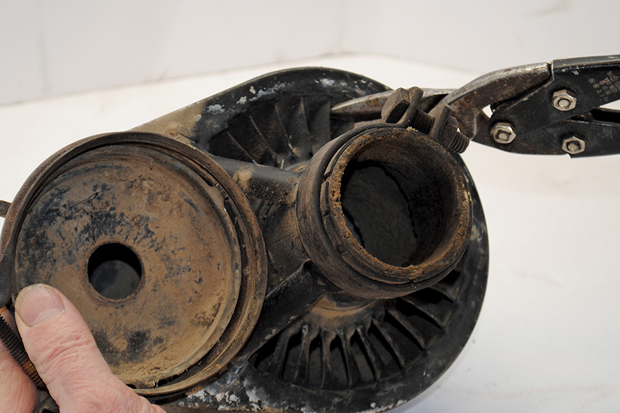 Rusted air filter housing being disassembled for restoration
