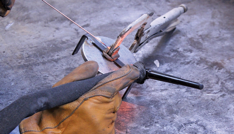 Welding in progress, securing metal parts during a vehicle restoration