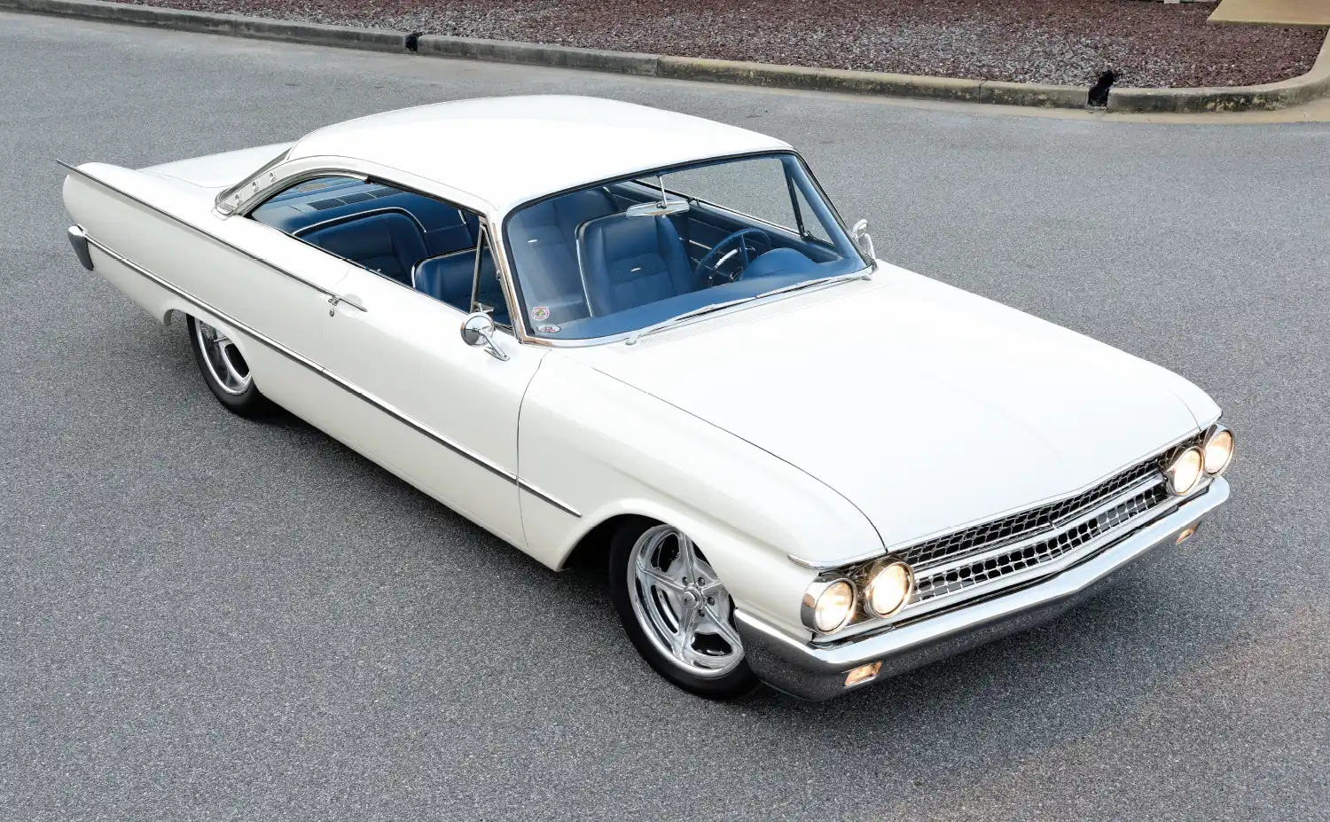 Overhead shot of 1961 Ford Galaxie Starliner, highlighting white exterior and blue interior