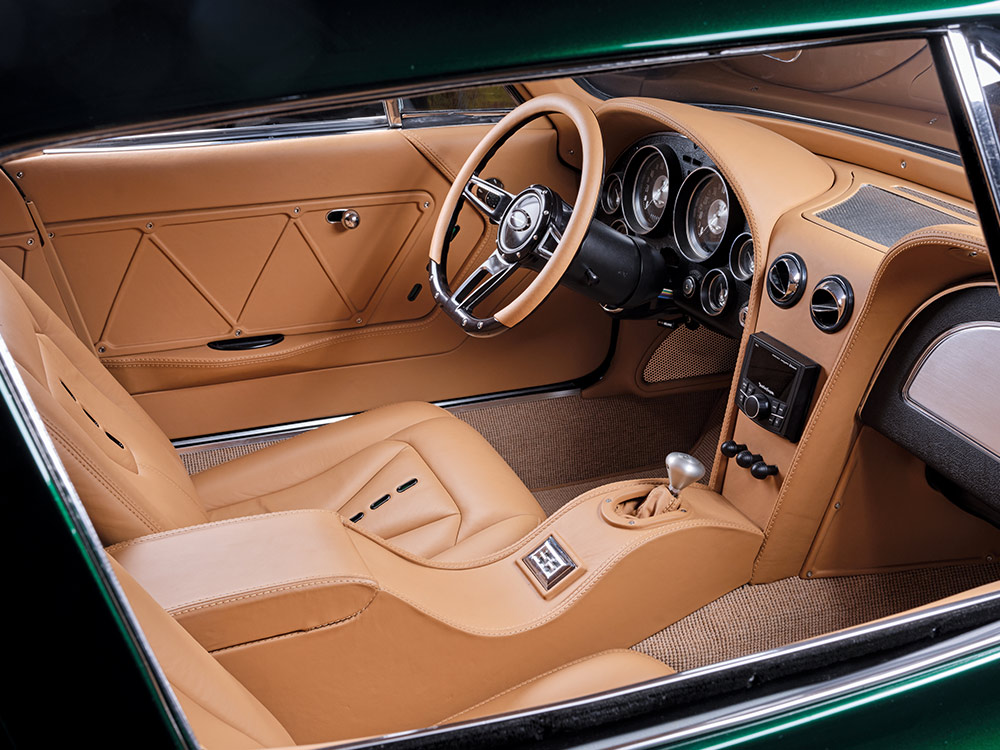 Interior view of a 1966 Chevrolet Corvette Stingray featuring tan leather seats and a custom dashboard