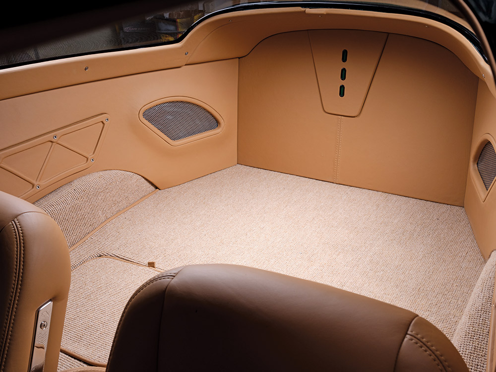 Rear compartment area of the 1966 Chevrolet Corvette Stingray, with tan leather and custom carpeting