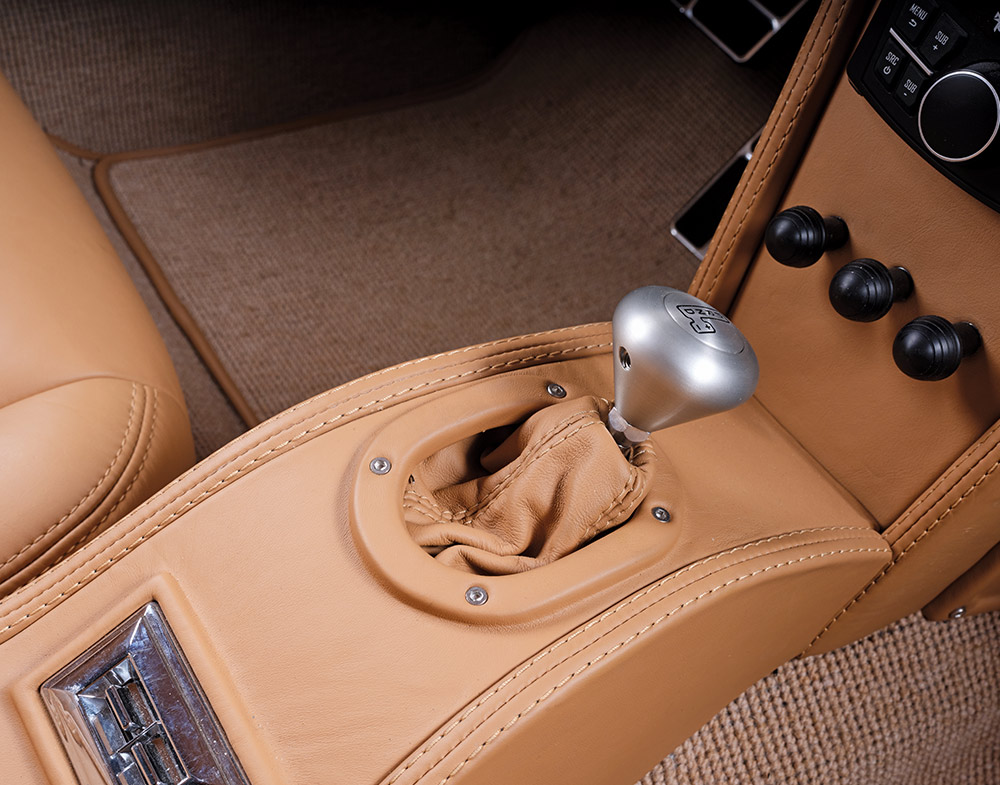 Close-up of the 1966 Corvette Stingray's leather-wrapped shifter and custom center console
