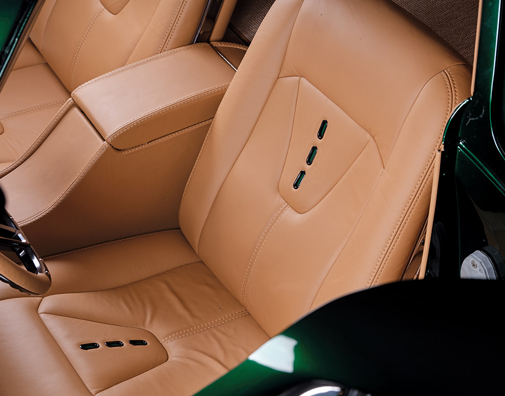 Tan leather seats inside the 1966 Chevrolet Corvette Stingray, showcasing custom stitching and sleek design