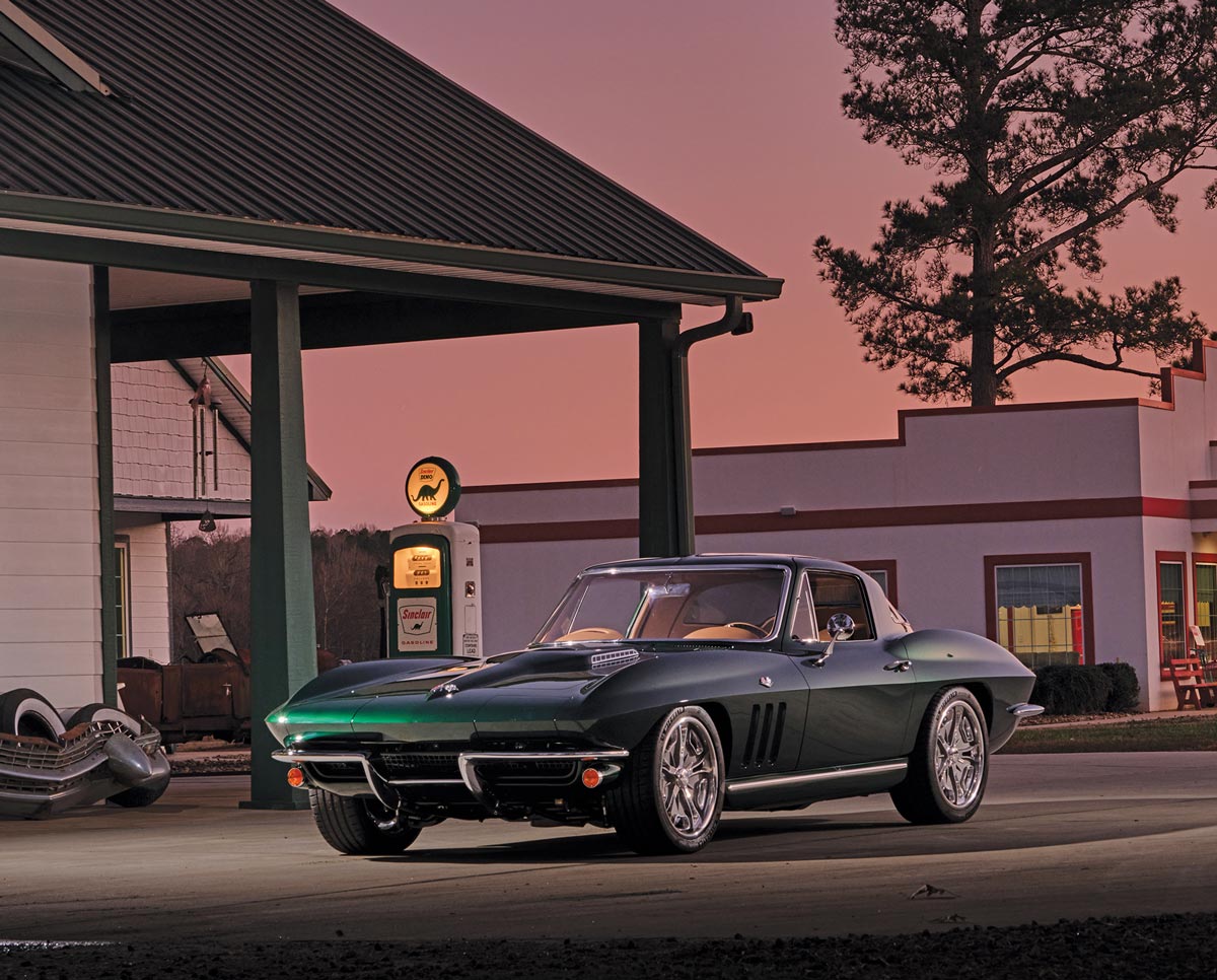 1966 Chevrolet Corvette Stingray parked at sunset near a vintage gas station with a purple and orange sky