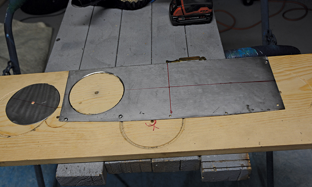Metal panel with cut gauge holes, ready for installation in a custom dashboard