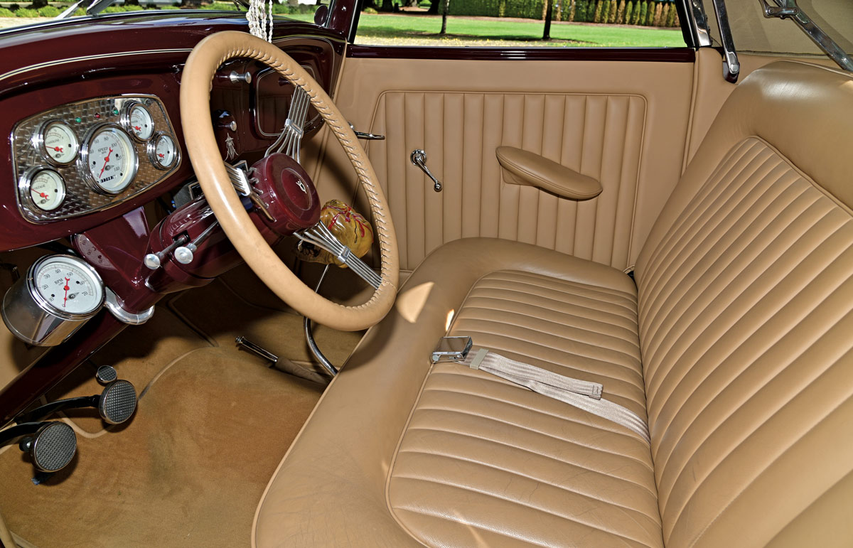 tan front seats and steering wheel inside of burgundy 1933 Ford Cabriolet