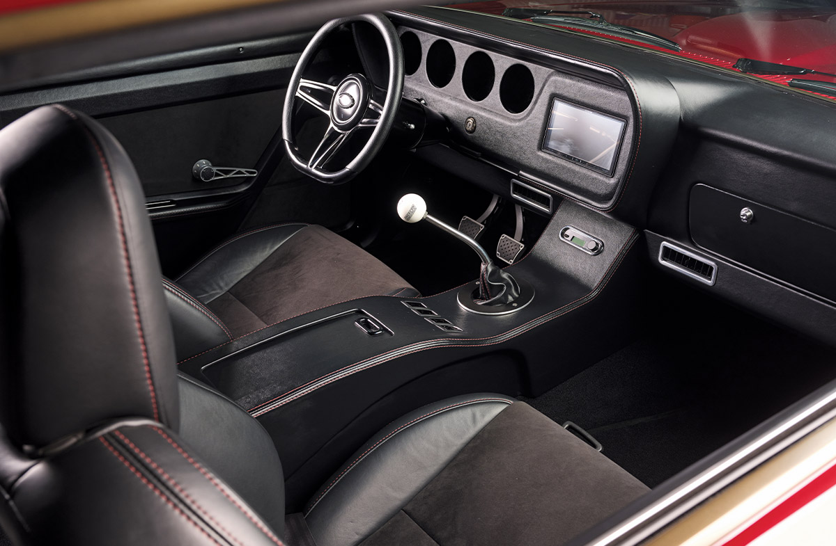 front seating and dash of a red 1966 Pontiac GTO