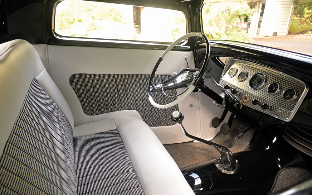 1932 Ford Coupe interior with white and black houndstooth bench seat and matching door panel upholstery