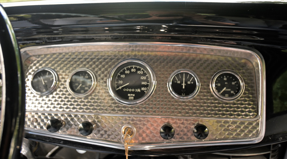 1932 Ford Coupe dashboard showing detailed classic gauge cluster with speedometer, oil pressure, and temperature readings