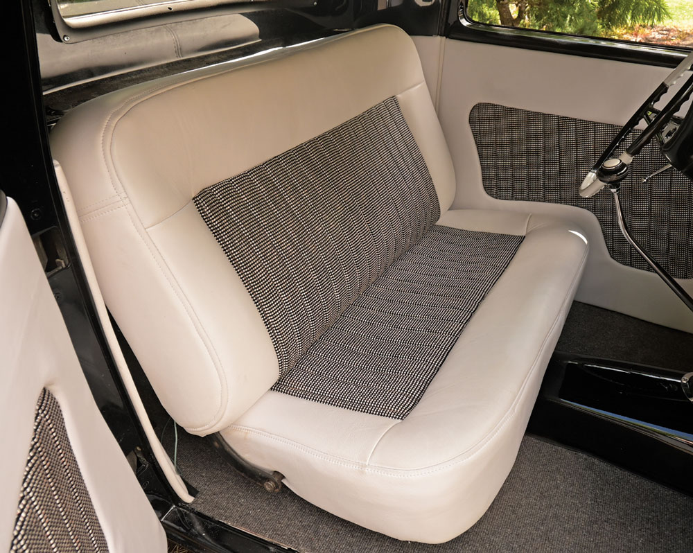 1932 Ford Coupe dashboard featuring engine-turned aluminum insert with classic gauges and a white steering wheel