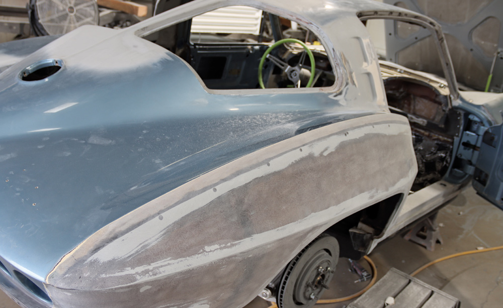 Fiberglass repair and body smoothing on a C2 Corvette, focusing on rear quarter panel refinishing