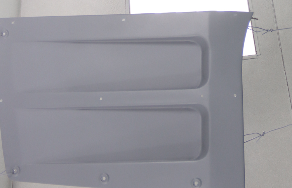 Primed C2 Corvette hood undergoing prep work with smooth fiberglass finish for final painting