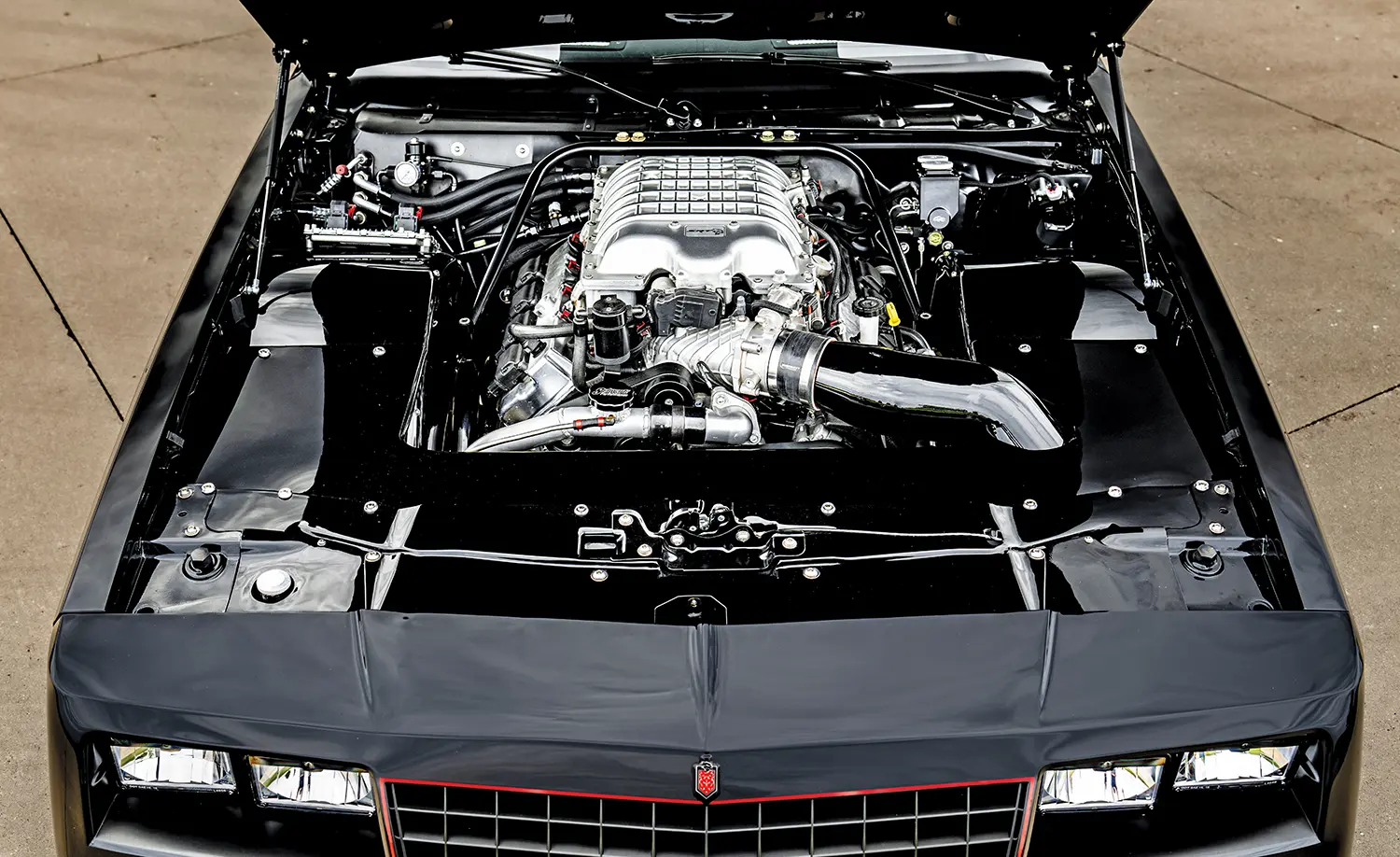 Detailed engine view 1985 Chevy Monte Carlo custom supercharged engine high performance build black polished bay