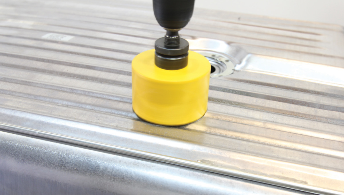 Fuel tank modification using a hole saw for Holley Sniper EFI pump installation