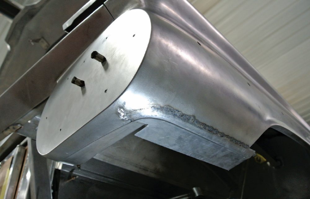 underbody view of a 1959 Chevy Impala showing custom fabrication and welded patch panels