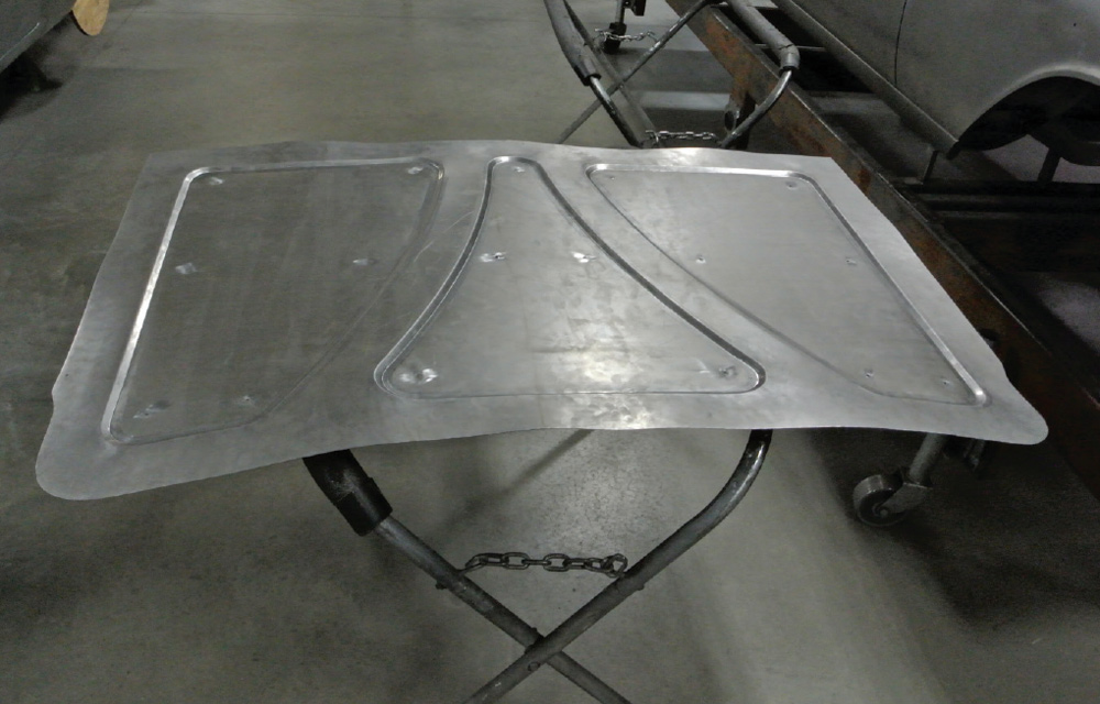 custom trunk panel in raw metal for a 1959 Chevy Impala, displaying reinforcement channels